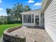 Charming outdoor patio with brick pavers and a low stone wall, ideal for relaxing and enjoying the outdoors at 17427 Se 72Nd Overbrook Ct, The Villages, FL 32162