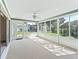 Bright sunroom with multiple windows offering backyard views, and access to the home's exterior at 17427 Se 72Nd Overbrook Ct, The Villages, FL 32162