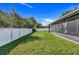 The fully-fenced backyard features a well-maintained lawn and a screened lanai at 1761 Country Terrace Ln, Apopka, FL 32703