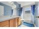 Well-lit bathroom featuring a vanity with storage, a mirror, and a shower-tub combination with stylish curtains at 1761 Country Terrace Ln, Apopka, FL 32703