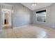 Spacious bedroom with tiled floor, neutral wall paint, and a window with blinds for a relaxing atmosphere at 1761 Country Terrace Ln, Apopka, FL 32703