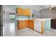 Kitchen featuring wood cabinets, a white countertop, white dishwasher, and view into the living room at 1761 Country Terrace Ln, Apopka, FL 32703