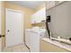 Efficient laundry room with washer, dryer, and storage cabinets for convenient household tasks at 1761 Country Terrace Ln, Apopka, FL 32703