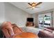 Relax in this cozy living room with plush seating, a ceiling fan, and access to the outdoor patio at 1761 Country Terrace Ln, Apopka, FL 32703