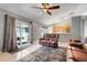 Open-concept living room with sliding glass doors, leading to outdoor patio, and adjacent to kitchen area at 1761 Country Terrace Ln, Apopka, FL 32703