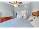 Comfortable primary bedroom with wood flooring, ceiling fan, and ensuite access at 1761 Country Terrace Ln, Apopka, FL 32703