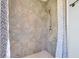 The stand-up shower features decorative tilework, a shower head with a detachable sprayer, and a small white base at 1761 Country Terrace Ln, Apopka, FL 32703