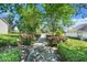 Beautifully landscaped walkway lined with flowering bushes and lush greenery at 1761 Country Terrace Ln, Apopka, FL 32703