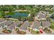 A stunning aerial shot captures a home nestled beside a serene lake, complemented by verdant landscaping and peaceful surroundings at 17800 Se 91St Gaylark Ave, The Villages, FL 32162