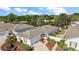A lovely single-story home features a view of the lake and a well-manicured lawn at 17800 Se 91St Gaylark Ave, The Villages, FL 32162