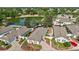 A serene aerial view of a home near a picturesque lake, surrounded by lush greenery and well-maintained landscaping at 17800 Se 91St Gaylark Ave, The Villages, FL 32162