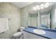Bathroom with blue countertops, patterned wallpaper, and shower at 17800 Se 91St Gaylark Ave, The Villages, FL 32162
