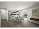 Open layout: dining area flows into kitchen, bar stool seating, and sliding glass doors at 17800 Se 91St Gaylark Ave, The Villages, FL 32162