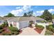 Charming single-story home featuring a well-maintained lawn, red shutters, and a white picket fence at 17800 Se 91St Gaylark Ave, The Villages, FL 32162
