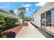 A well-maintained home exterior with a neatly landscaped side yard and sliding glass doors at 17800 Se 91St Gaylark Ave, The Villages, FL 32162