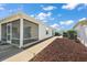 Home's exterior featuring a screened lanai, neat landscaping, and a well-maintained walkway at 17800 Se 91St Gaylark Ave, The Villages, FL 32162