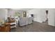 Spacious living room with tile floors, comfortable seating, and access to outdoor space at 17800 Se 91St Gaylark Ave, The Villages, FL 32162