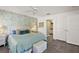 Bright bedroom with floral wallpaper, ensuite bathroom, and tiled floors at 17800 Se 91St Gaylark Ave, The Villages, FL 32162