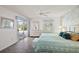 This bedroom boasts ample natural light, sliding doors to a balcony, and an ensuite bathroom at 17800 Se 91St Gaylark Ave, The Villages, FL 32162