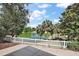 Enjoy serene pond views from this lovely backyard, framed by lush trees and palms at 17800 Se 91St Gaylark Ave, The Villages, FL 32162