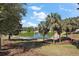 Picturesque pond view surrounded by palm trees and greenery, perfect for relaxation at 17800 Se 91St Gaylark Ave, The Villages, FL 32162