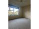 Bedroom with a ceiling fan, neutral carpet, and a window view to the front yard at 1812 Sanibel Ct, The Villages, FL 32162