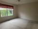 Bedroom featuring a ceiling fan, carpet flooring and a window at 1812 Sanibel Ct, The Villages, FL 32162