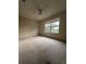 Bedroom with a ceiling fan, neutral carpet and window to the yard at 1812 Sanibel Ct, The Villages, FL 32162
