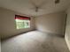 Bedroom featuring a ceiling fan, carpet flooring and a window at 1812 Sanibel Ct, The Villages, FL 32162