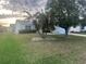 Well-maintained front yard with mature trees and landscaping complementing the home's exterior at 1812 Sanibel Ct, The Villages, FL 32162