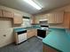 Functional kitchen featuring wooden cabinets, a gas range, and a practical breakfast bar area at 1812 Sanibel Ct, The Villages, FL 32162