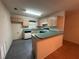 Kitchen featuring wooden cabinets, a gas range, a breakfast bar, and durable tiled floors at 1812 Sanibel Ct, The Villages, FL 32162