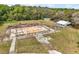 Aerial view of lot featuring barn, foundation, and surrounding trees showcasing land and building features at 19621 Lake Lincoln Ln, Eustis, FL 32736