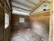 Interior of a rustic barn with wooden walls and open windows, offering a glimpse into its character at 19621 Lake Lincoln Ln, Eustis, FL 32736