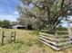 Rustic barn set in a picturesque landscape, offering character and potential for various uses at 19621 Lake Lincoln Ln, Eustis, FL 32736