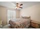 Cozy bedroom featuring a ceiling fan and a window bringing in natural light at 19621 Lake Lincoln Ln, Eustis, FL 32736