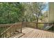 Wooden deck with railings overlooking lush green trees at 19621 Lake Lincoln Ln, Eustis, FL 32736