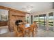 Cozy dining room with a brick fireplace and sliding glass doors to a scenic outdoor space at 19621 Lake Lincoln Ln, Eustis, FL 32736