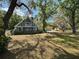 Charming two-story home with a covered porch surrounded by mature trees and a sprawling front yard at 19621 Lake Lincoln Ln, Eustis, FL 32736
