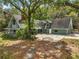A-frame home featuring a large yard, mature trees, and a spacious driveway at 19621 Lake Lincoln Ln, Eustis, FL 32736