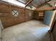 Wood-paneled interior room with concrete floor, natural light, and a door, perfect for storage or customization at 19621 Lake Lincoln Ln, Eustis, FL 32736