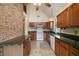 Bright kitchen with wood cabinets, granite countertops and white appliances at 19621 Lake Lincoln Ln, Eustis, FL 32736