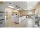 Large eat-in kitchen with white cabinets, center island, lots of light, and tile floors at 19621 Lake Lincoln Ln, Eustis, FL 32736