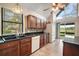 Spacious kitchen featuring wood cabinets, granite countertops, and stainless steel appliances at 19621 Lake Lincoln Ln, Eustis, FL 32736