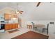 Kitchen and dining area with brown cabinets, good natural light, and linoleum floors at 19621 Lake Lincoln Ln, Eustis, FL 32736