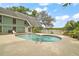 Back exterior view of home with an in-ground kidney shaped pool and a white fence line in the distance at 19621 Lake Lincoln Ln, Eustis, FL 32736