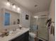 Bright bathroom featuring a shower, toilet, modern vanity with white marble countertops, and decorative touches at 1978 Lockett Ln, The Villages, FL 34762