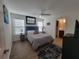 Serene bedroom with soft lighting, comfortable bed, and view into en-suite bathroom at 1978 Lockett Ln, The Villages, FL 34762