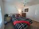 Cozy bedroom with a comfortable bed, dresser, and a ceiling fan for added comfort at 1978 Lockett Ln, The Villages, FL 34762