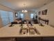 Open kitchen overlooking the living area, featuring seating area and stainless steel appliances at 1978 Lockett Ln, The Villages, FL 34762